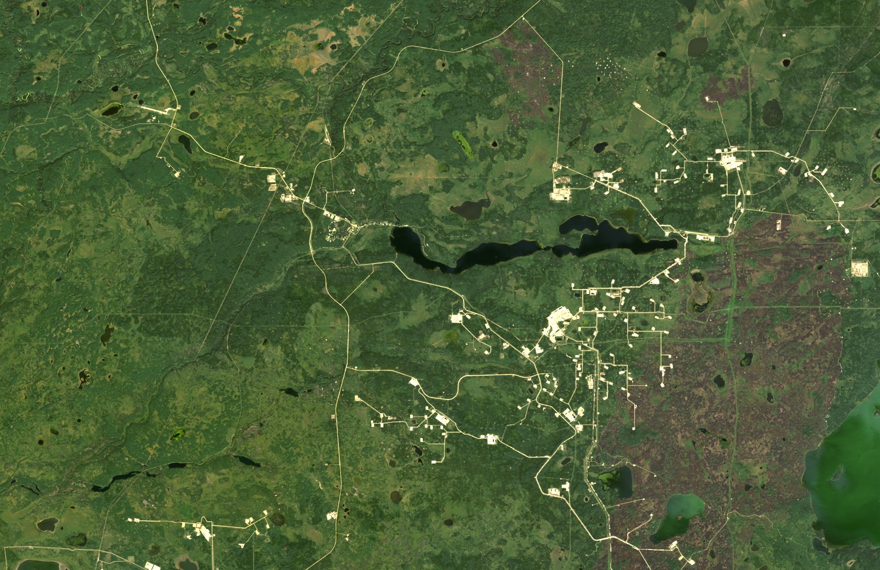 The same area in 2025, now covered by a network of roads, well pads and oil sands facilities